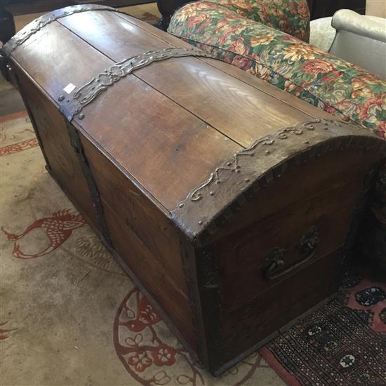 A large 19th century French iron bound oak dome top trunk, W.4ft 6in.